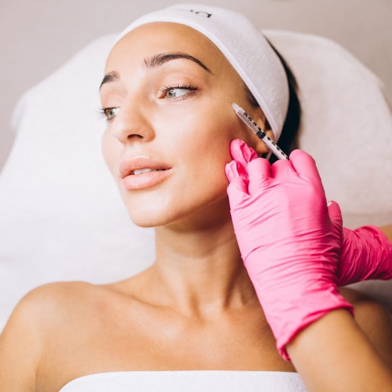 Cosmetologist making injections on a face of a woman in a beauty salon