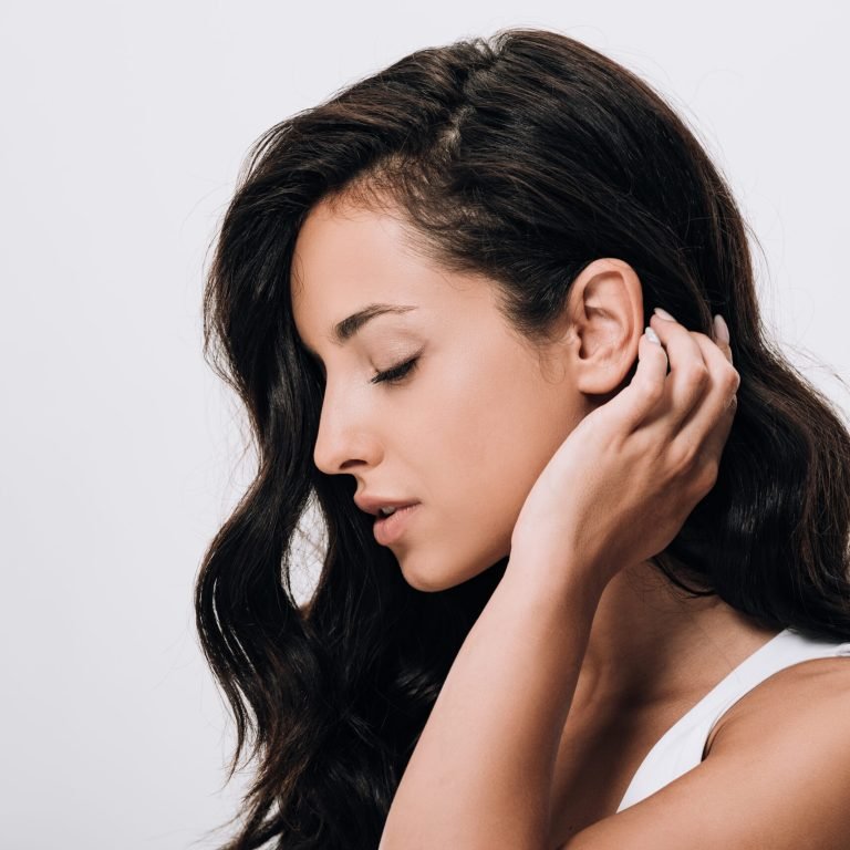 side view of tender brunette beautiful woman with long healthy and shiny hair isolated on grey